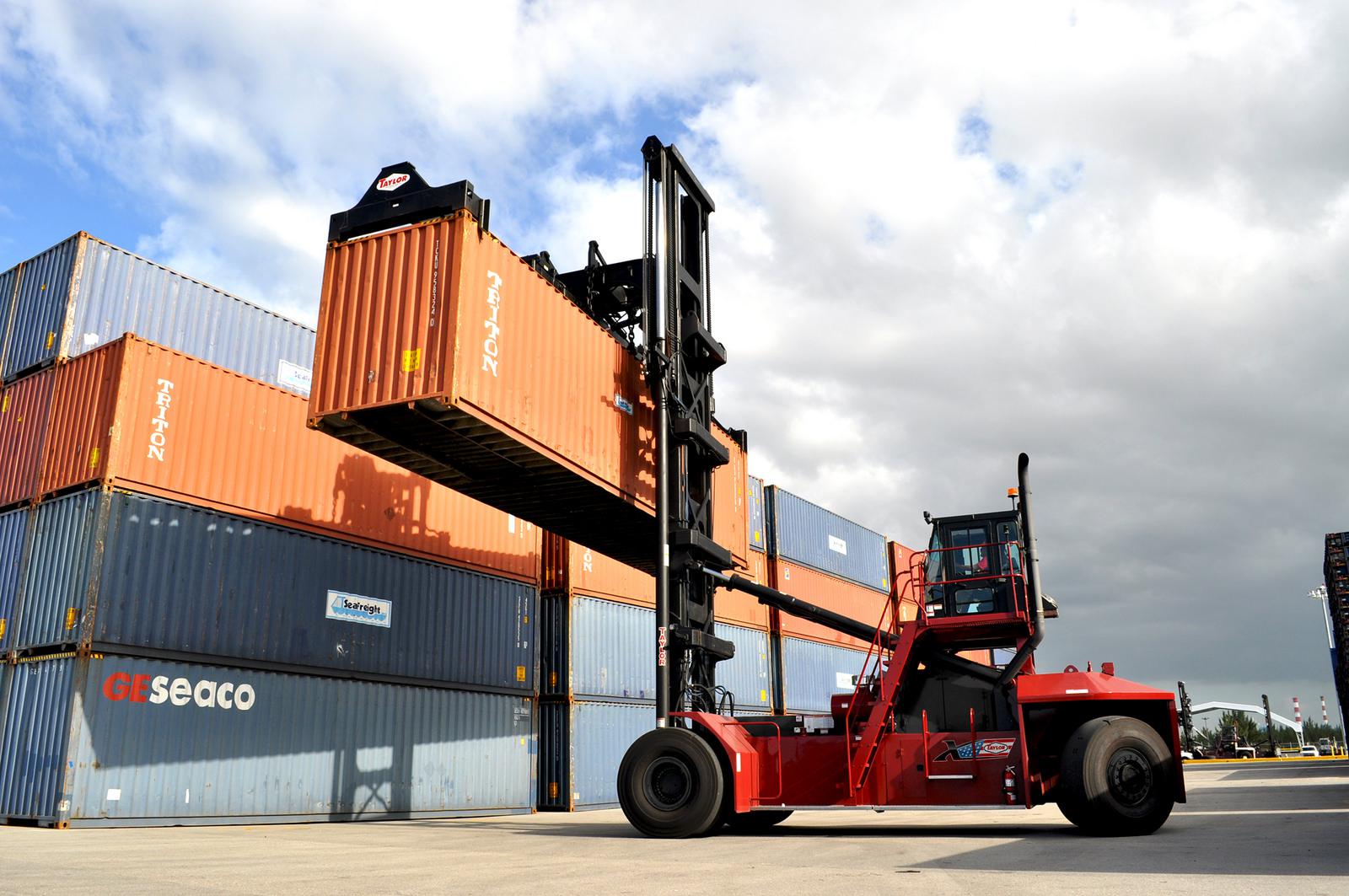 Forklift lifting up a shipping container